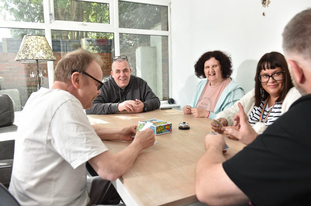 A carer and resident enjoying an activity at Hollybank.