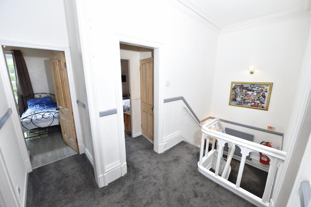Well-lit personal room with a desk and chair.